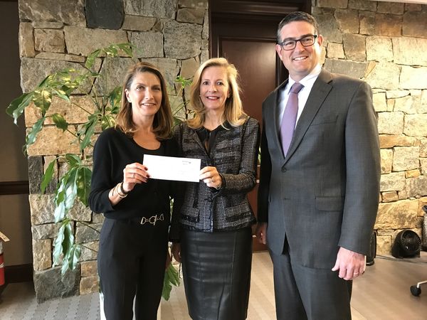 Laura Beck, Betsy Vitton and Doug Olin displaying check